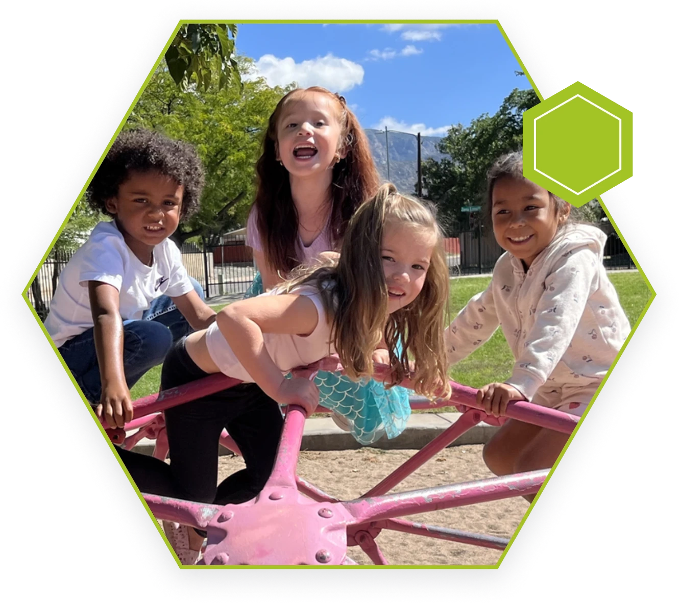 A group of children playing on a pink teeter totter.