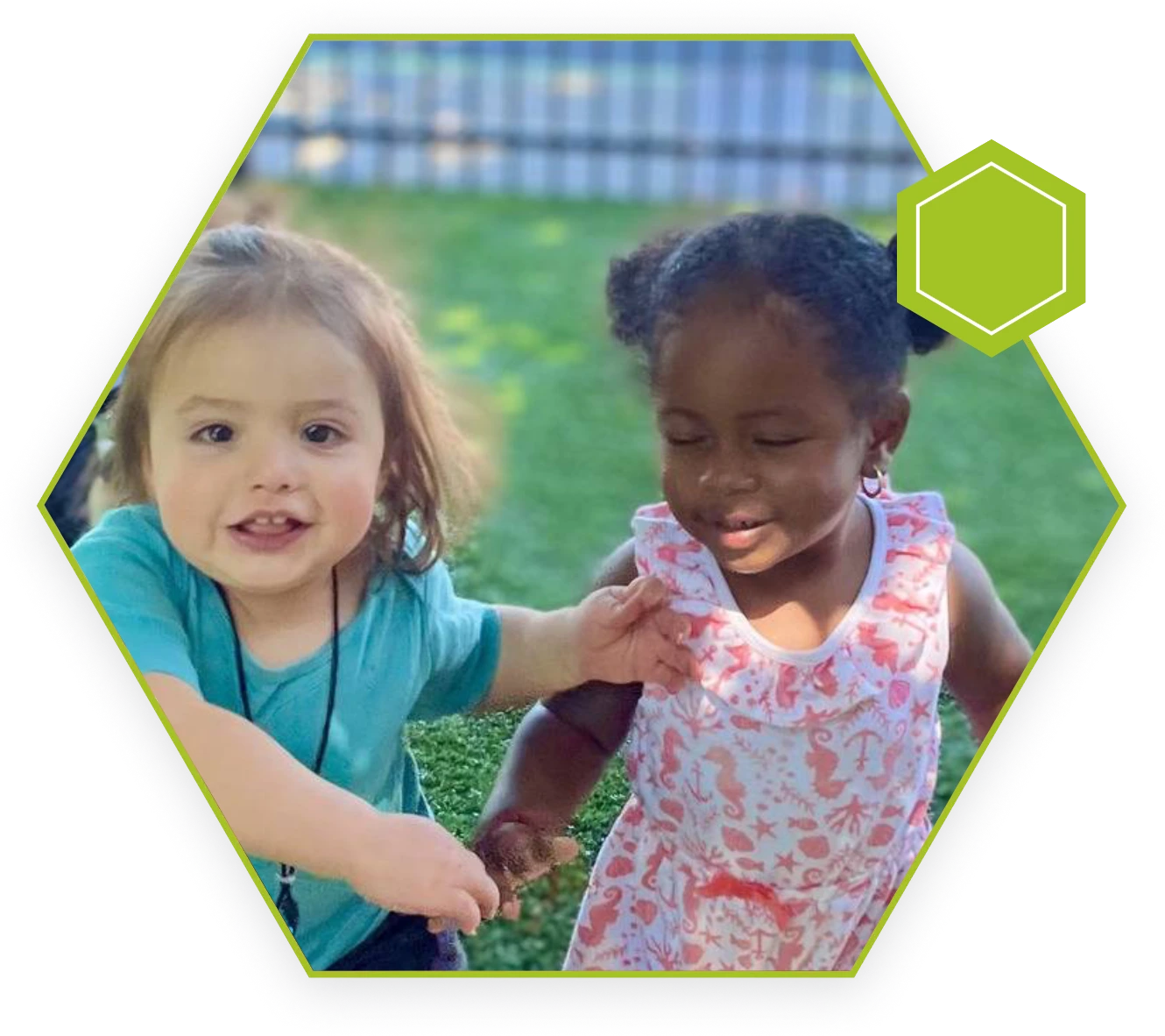 Two young children are playing together outside.