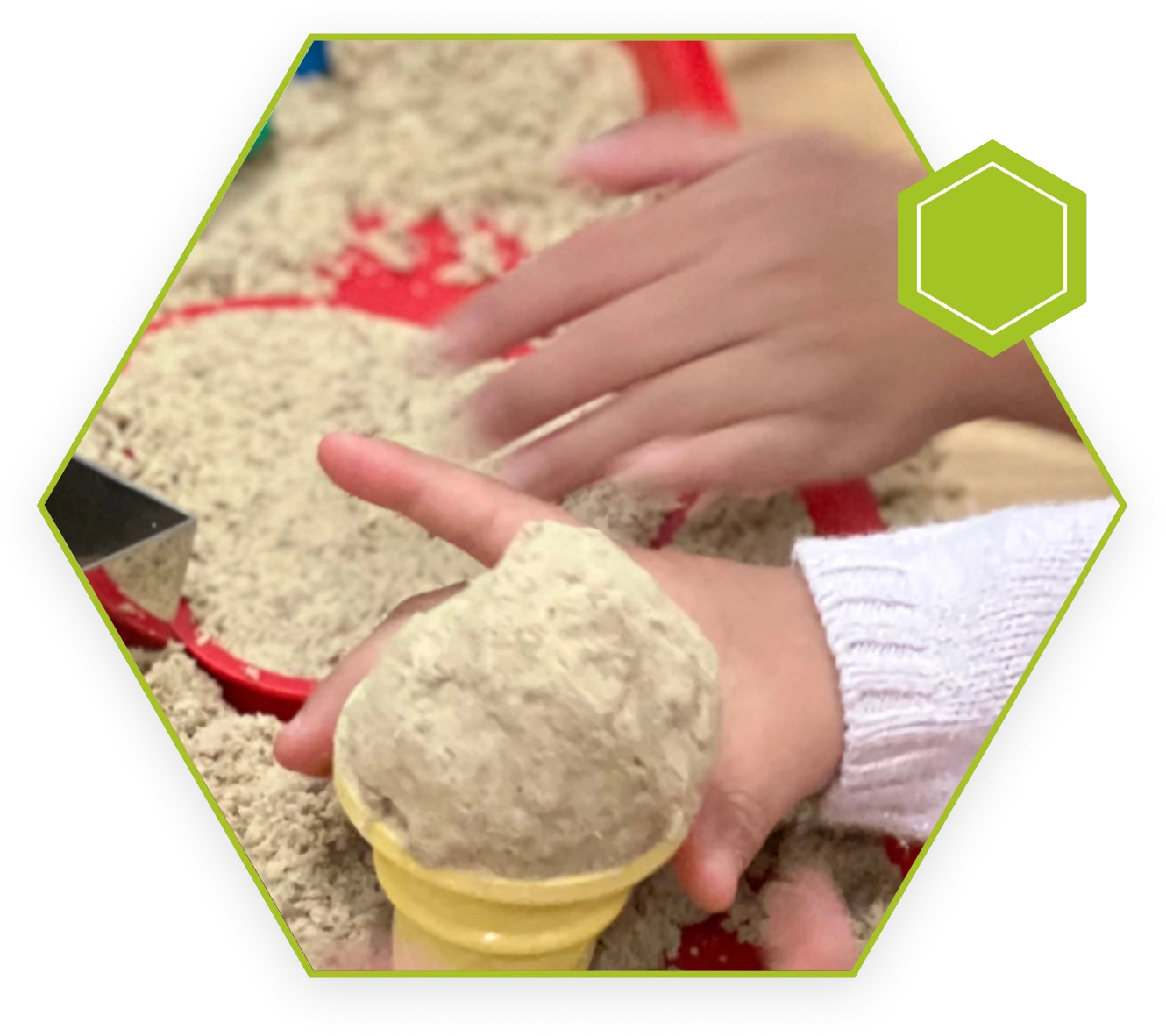 A person is playing with sand in their hands.