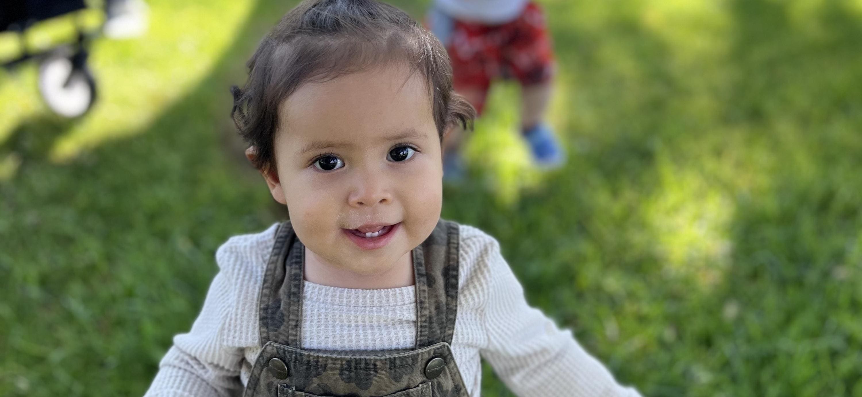 A little girl with blue eyes and brown hair.