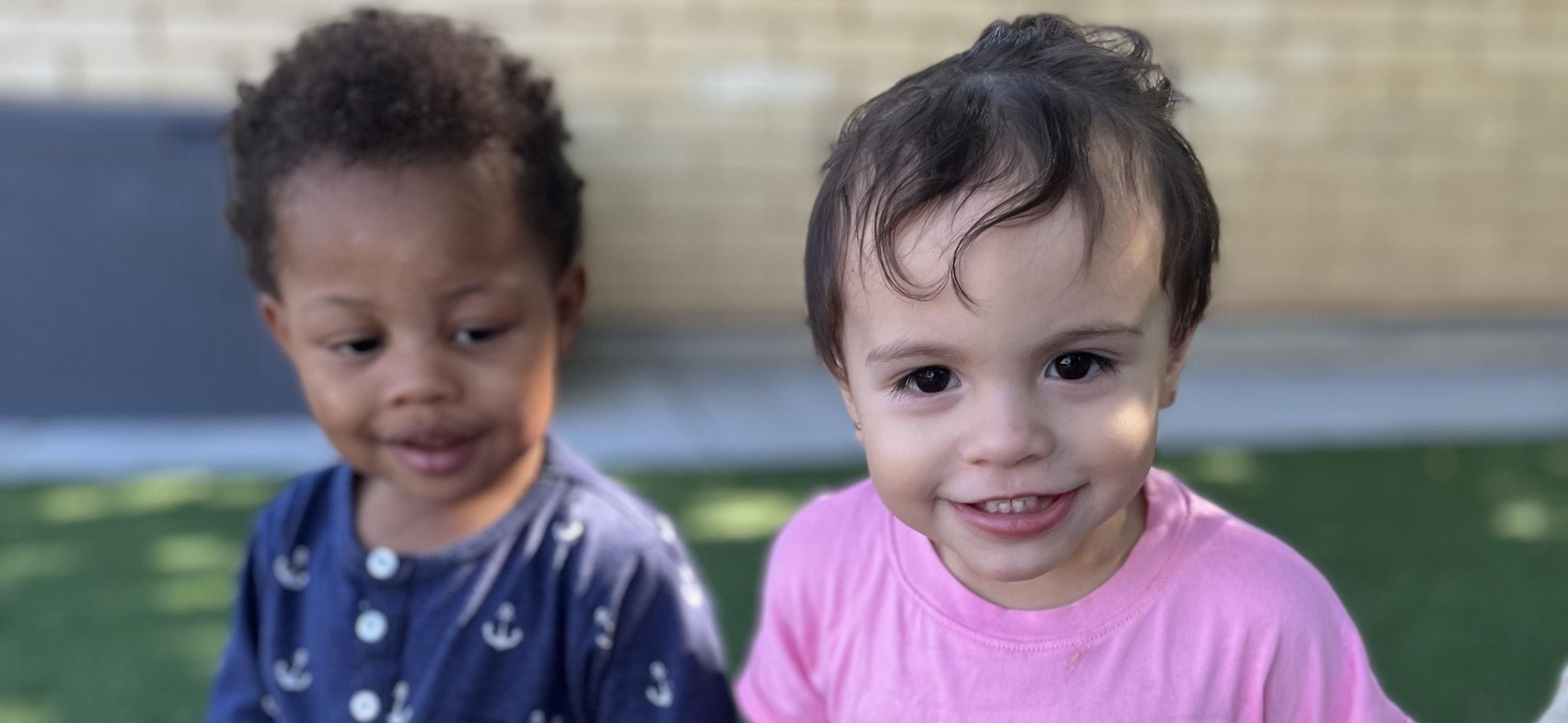 Two children are smiling for the camera.