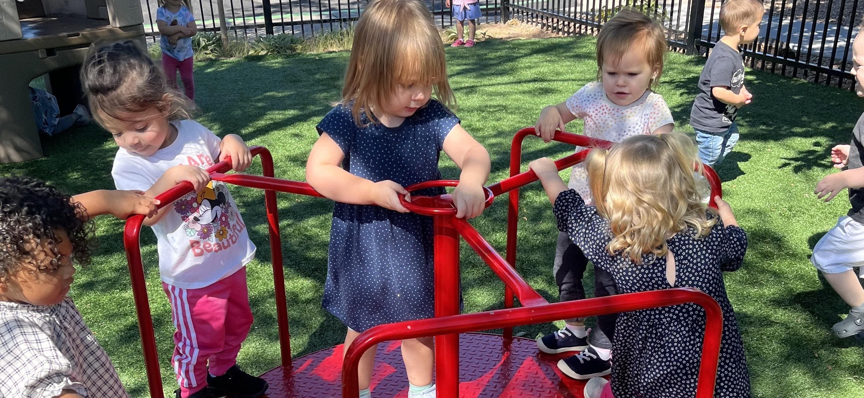 A group of children playing on some swings.